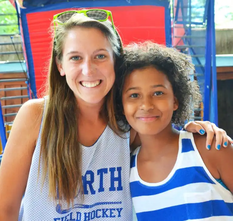 A counselor sharing a warm moment with a camper