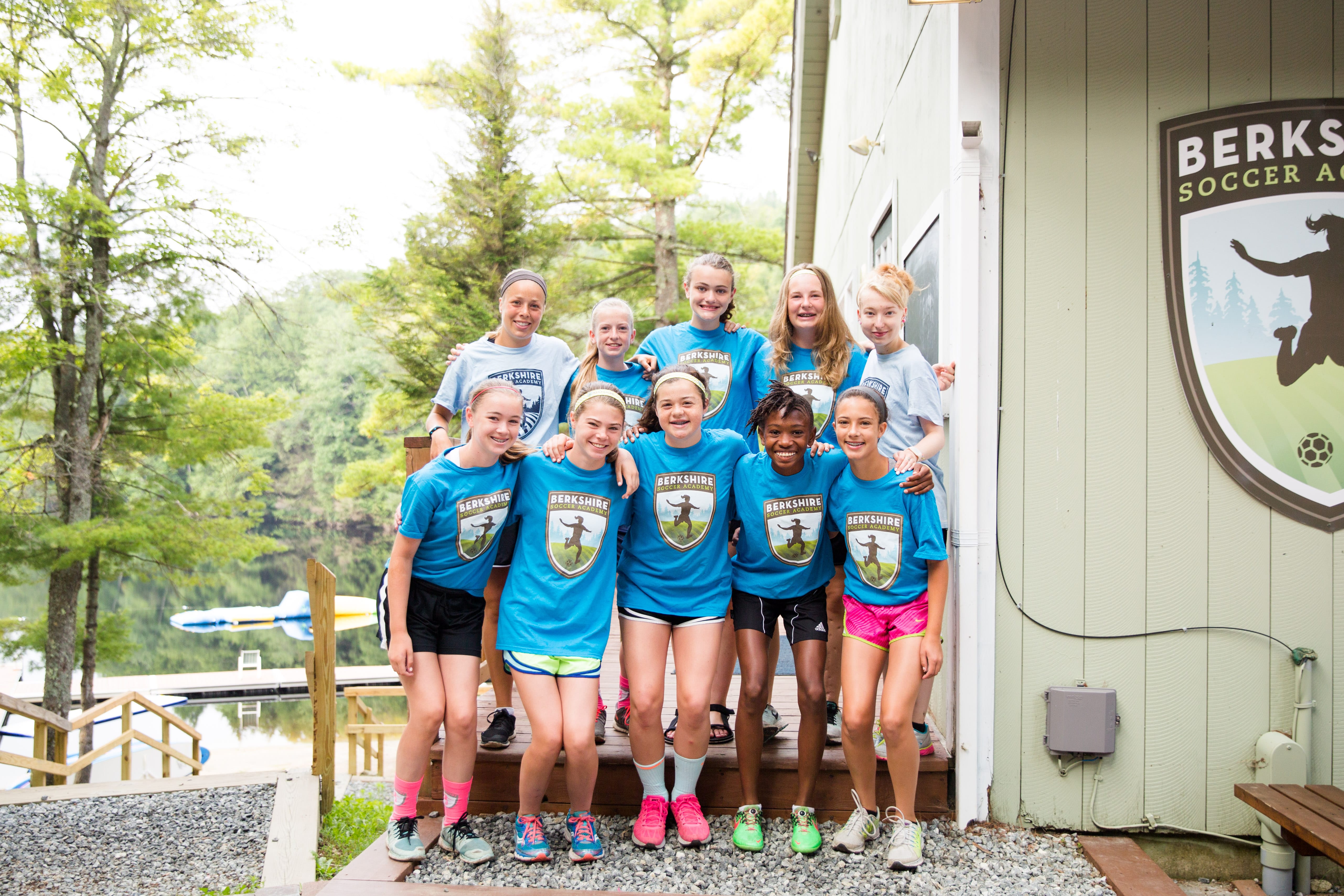 Group of camp counselors and campers smiling together