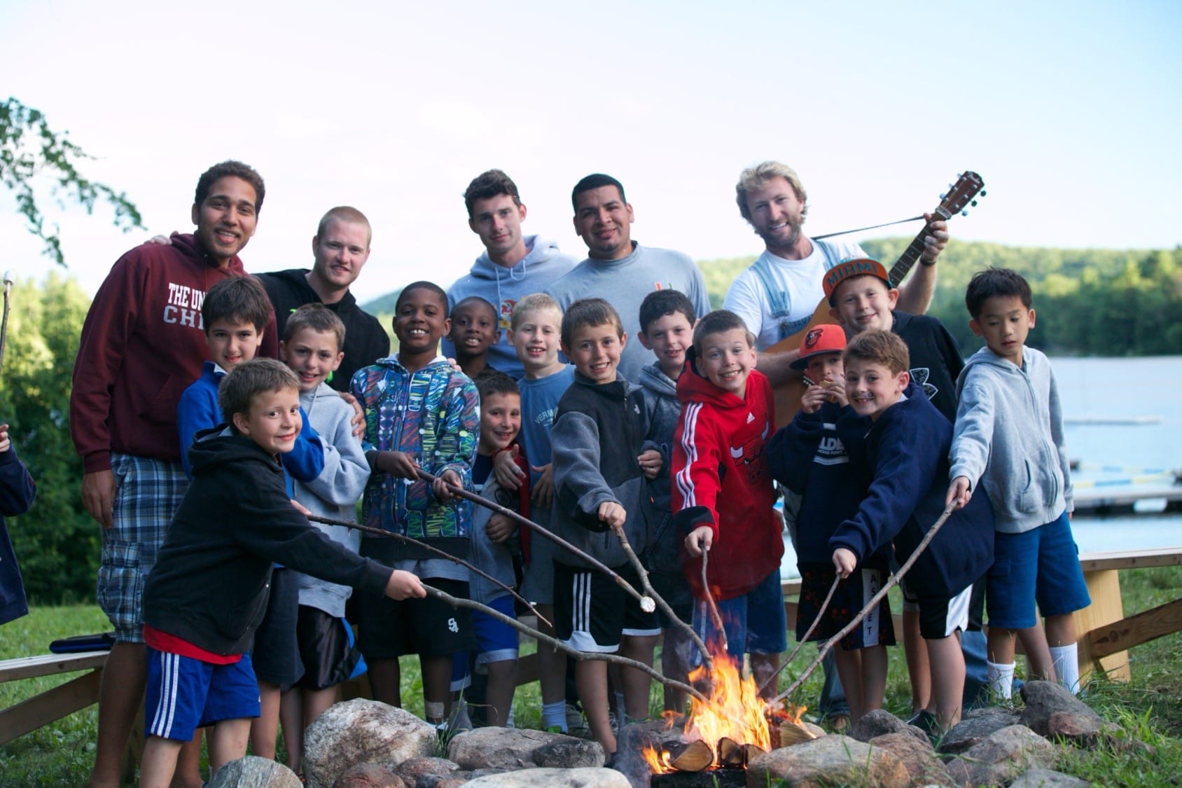 Campers and counselors gathered around a campfire