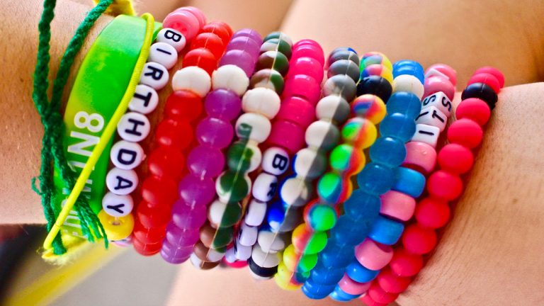 A camper showing off crafted friendship bracelets