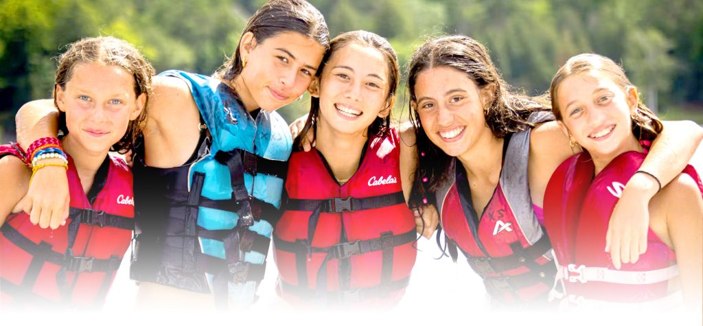 A group of smiling campers together at camp